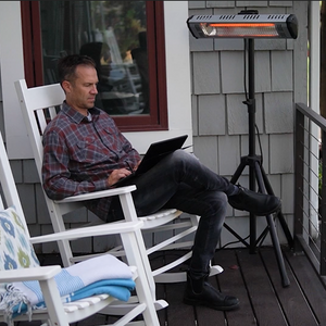 man enjoying heat storm infrared heater 1500 watt outdoor weatherproof patio heater.